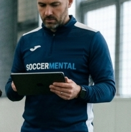 A coach reading the numbers on a tablet